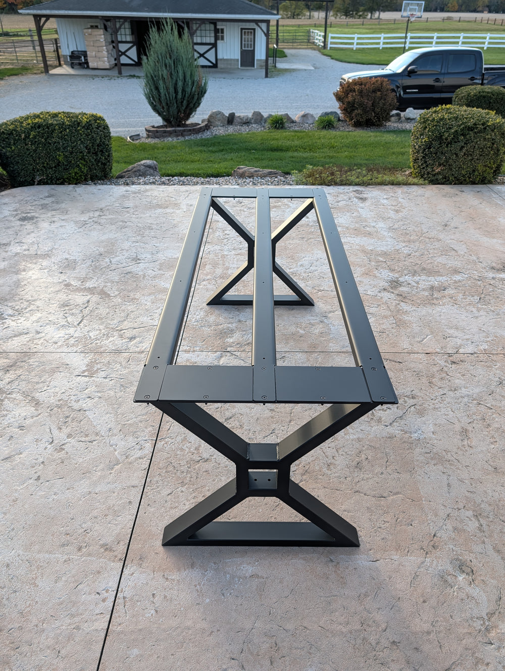 Steel support channels and connections on an Iron Edge Studio table base